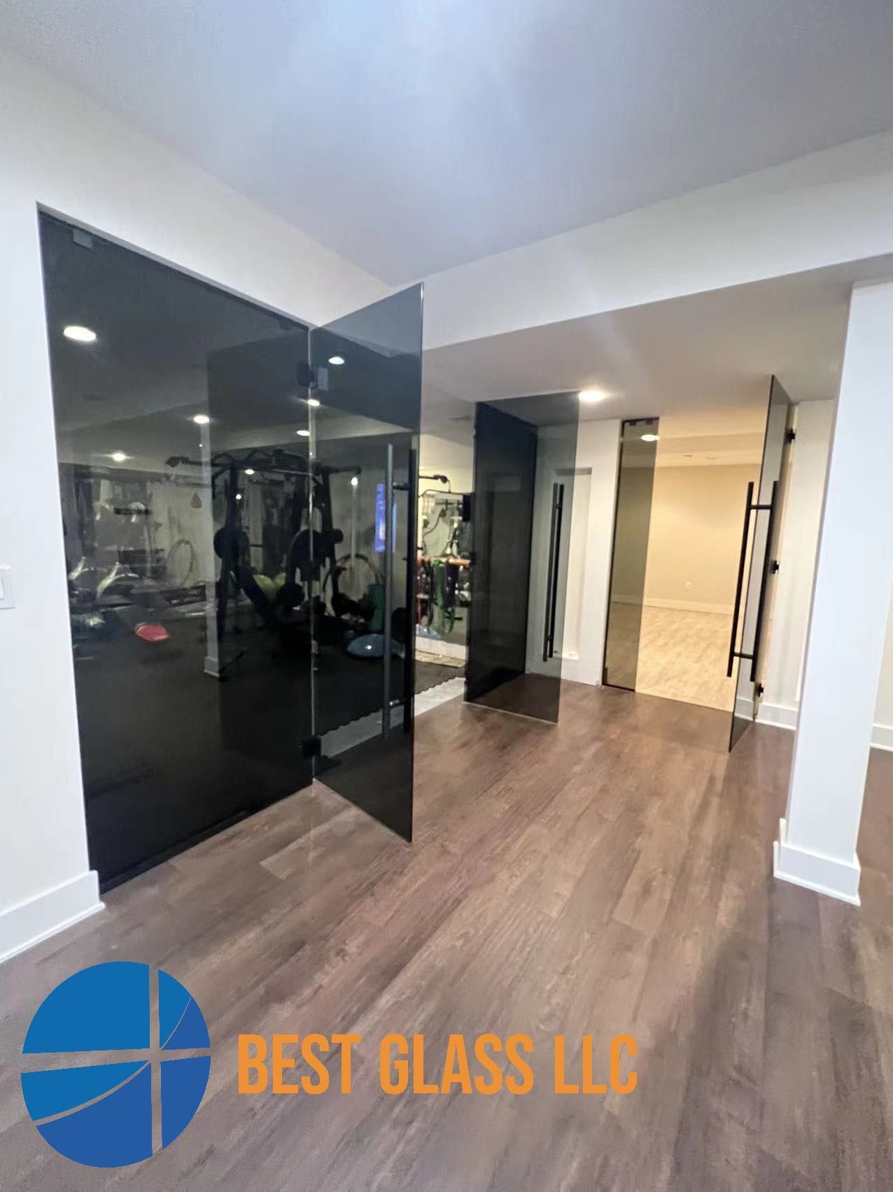 A room with a lot of glass doors and a gym in the background.