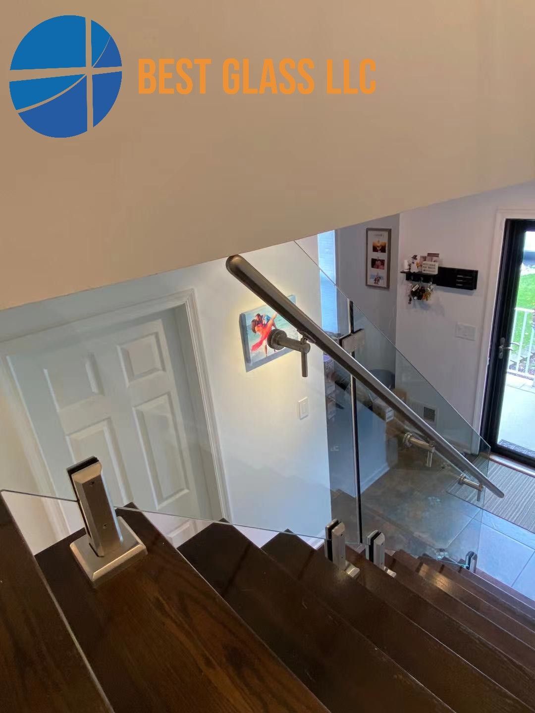 A picture of a staircase with a glass railing.