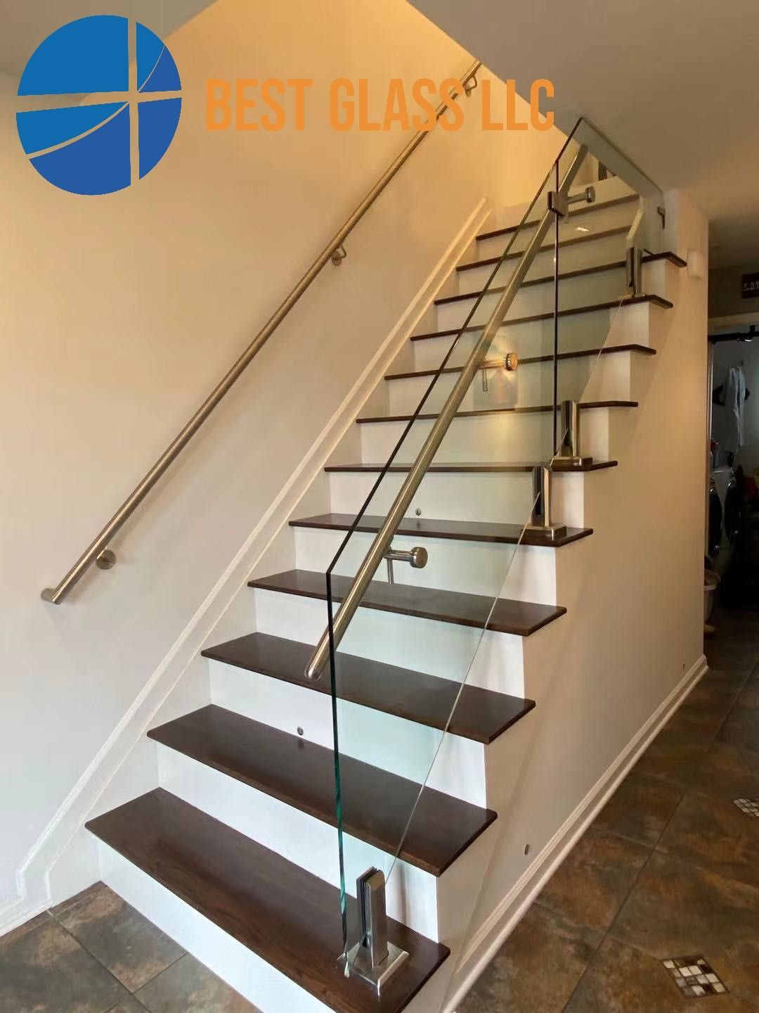 A staircase with a glass railing and wooden steps