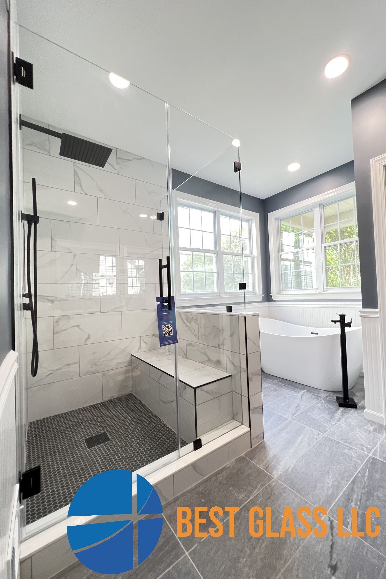 A bathroom with a walk in shower and a bathtub.