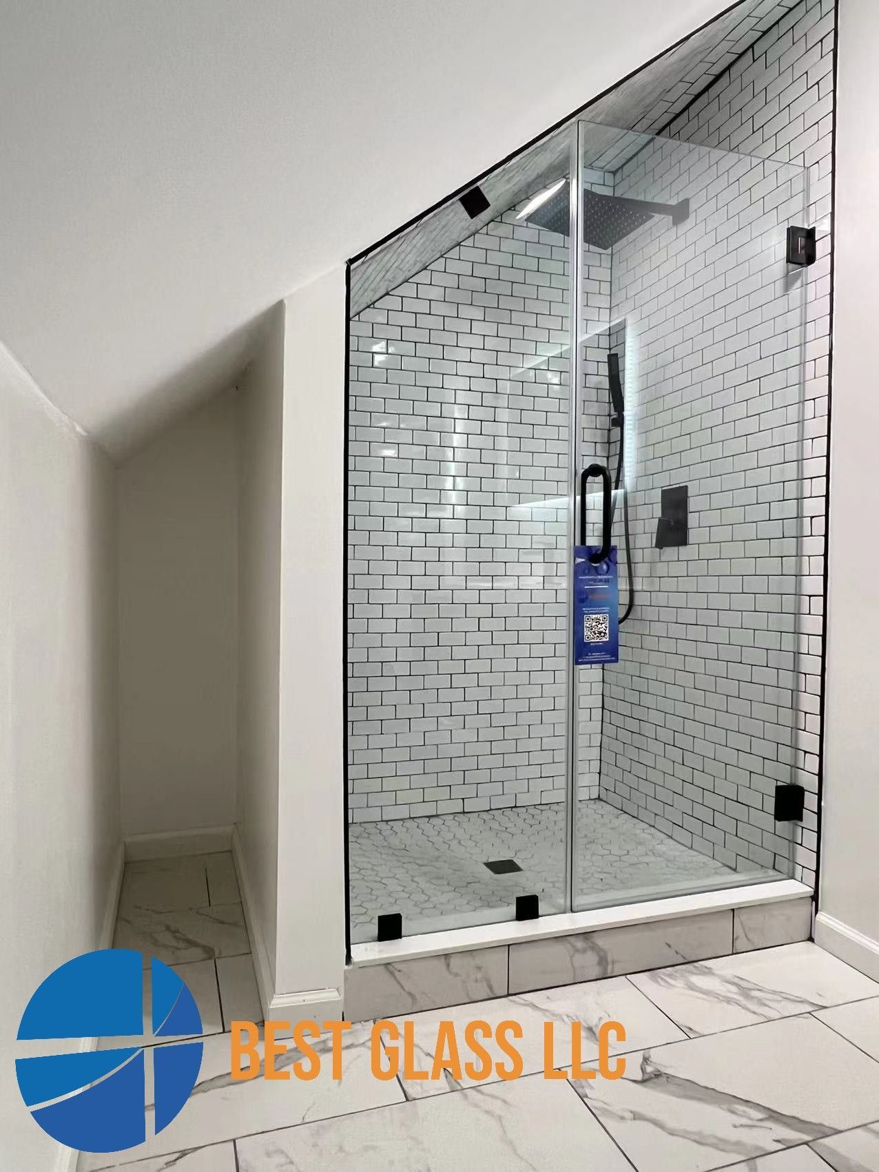 A bathroom with a walk in shower and a brick wall.