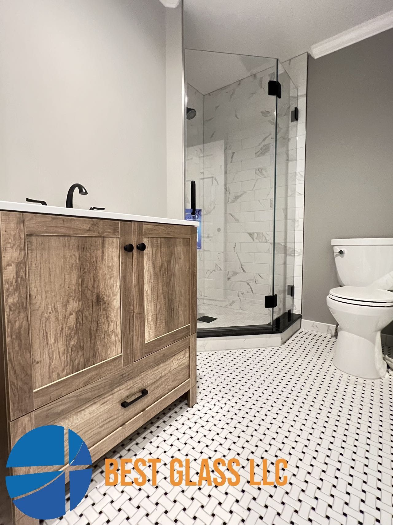 A bathroom with a sink , toilet , and shower stall.