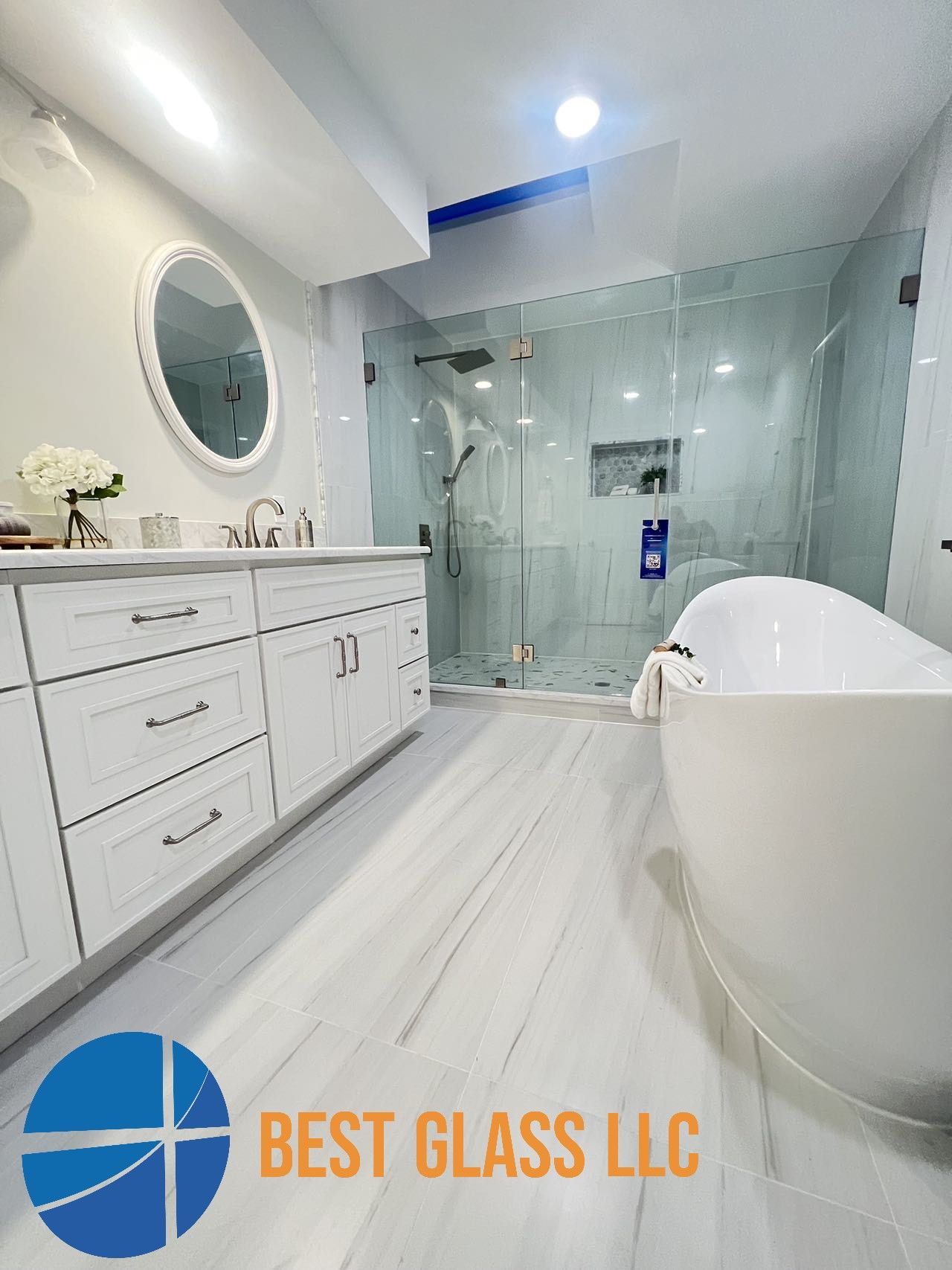 A bathroom with a bathtub , sink , shower and mirror.