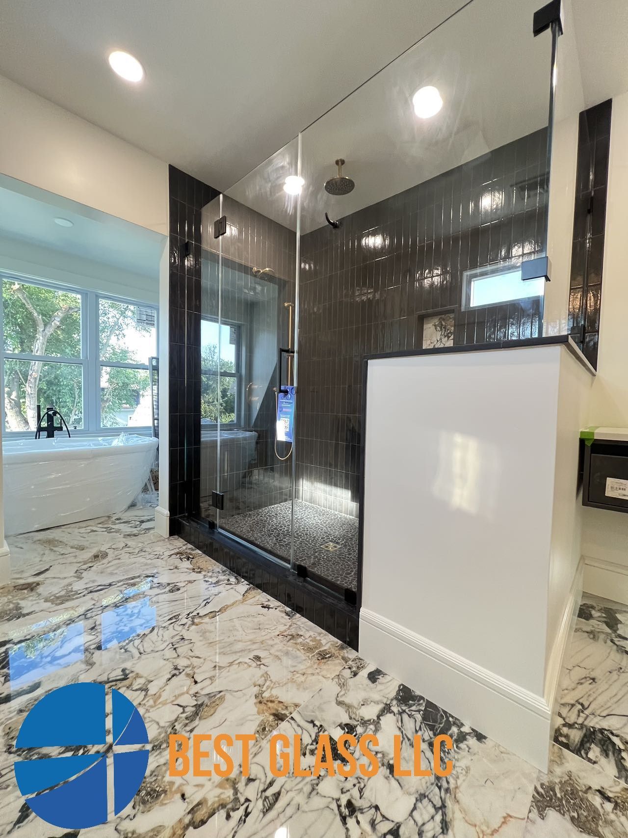 A bathroom with a walk in shower and a bathtub.