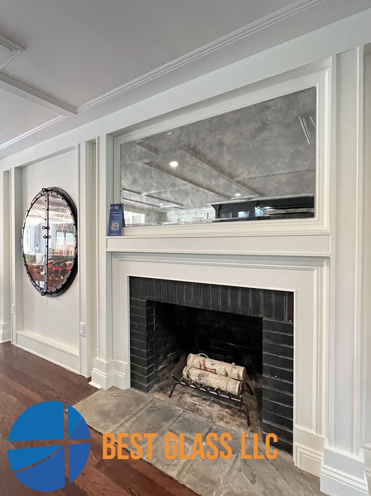 A living room with a fireplace and a mirror on the wall.