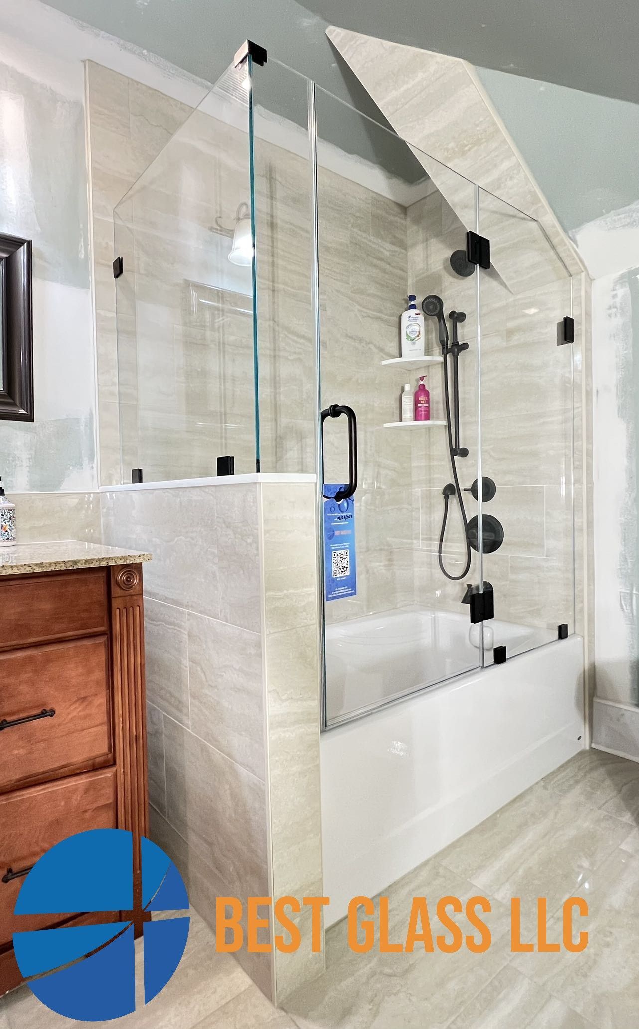 A bathroom with a walk in shower and a bathtub.