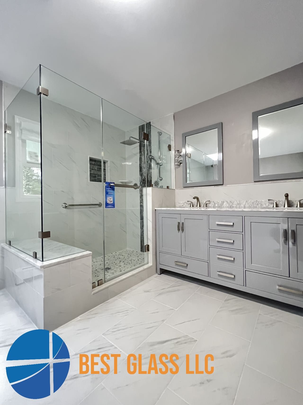 A bathroom with a walk in shower , sink and mirror.
