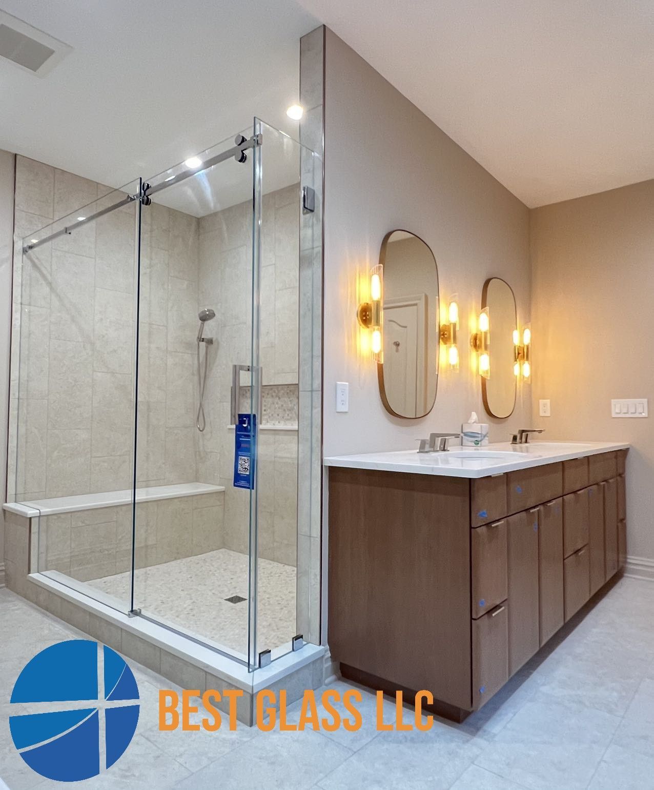 A bathroom with a sliding glass shower door and a sink