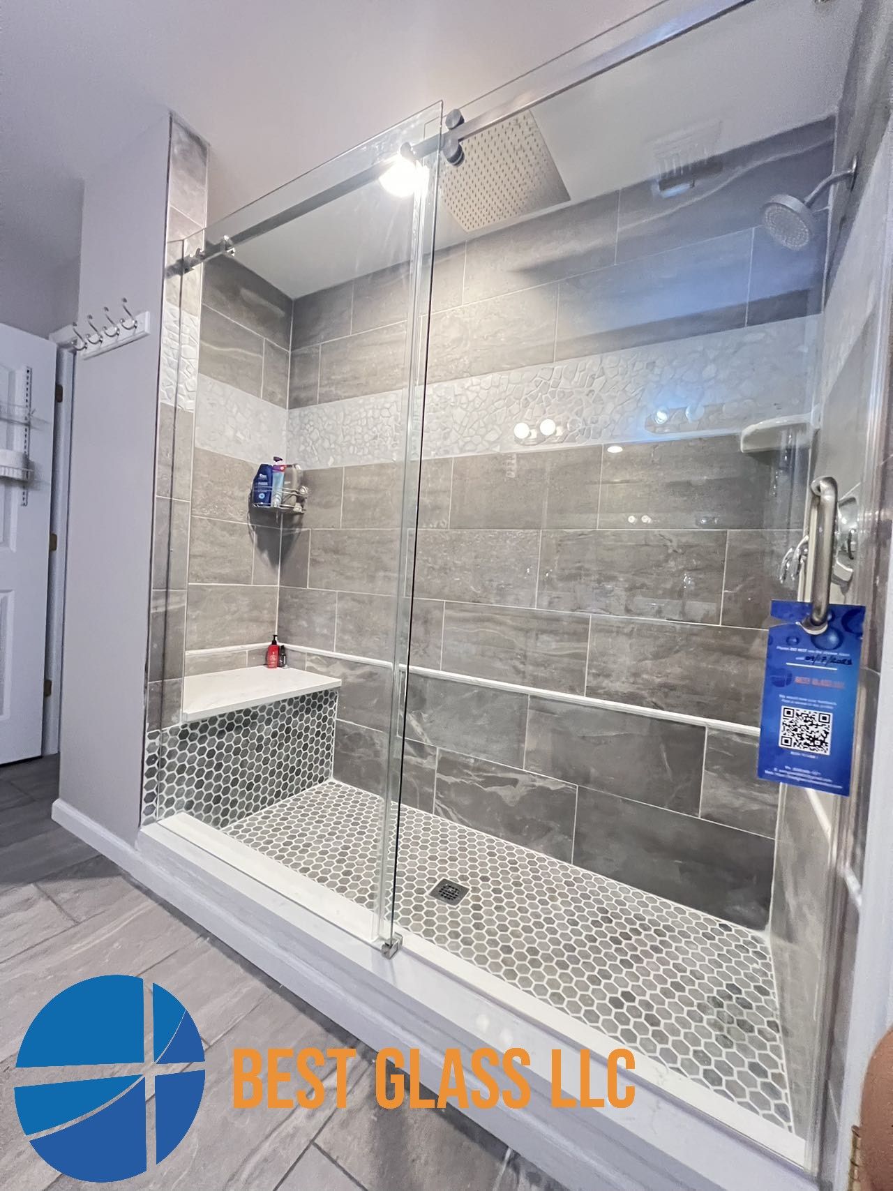 A bathroom with a walk in shower with sliding glass doors.