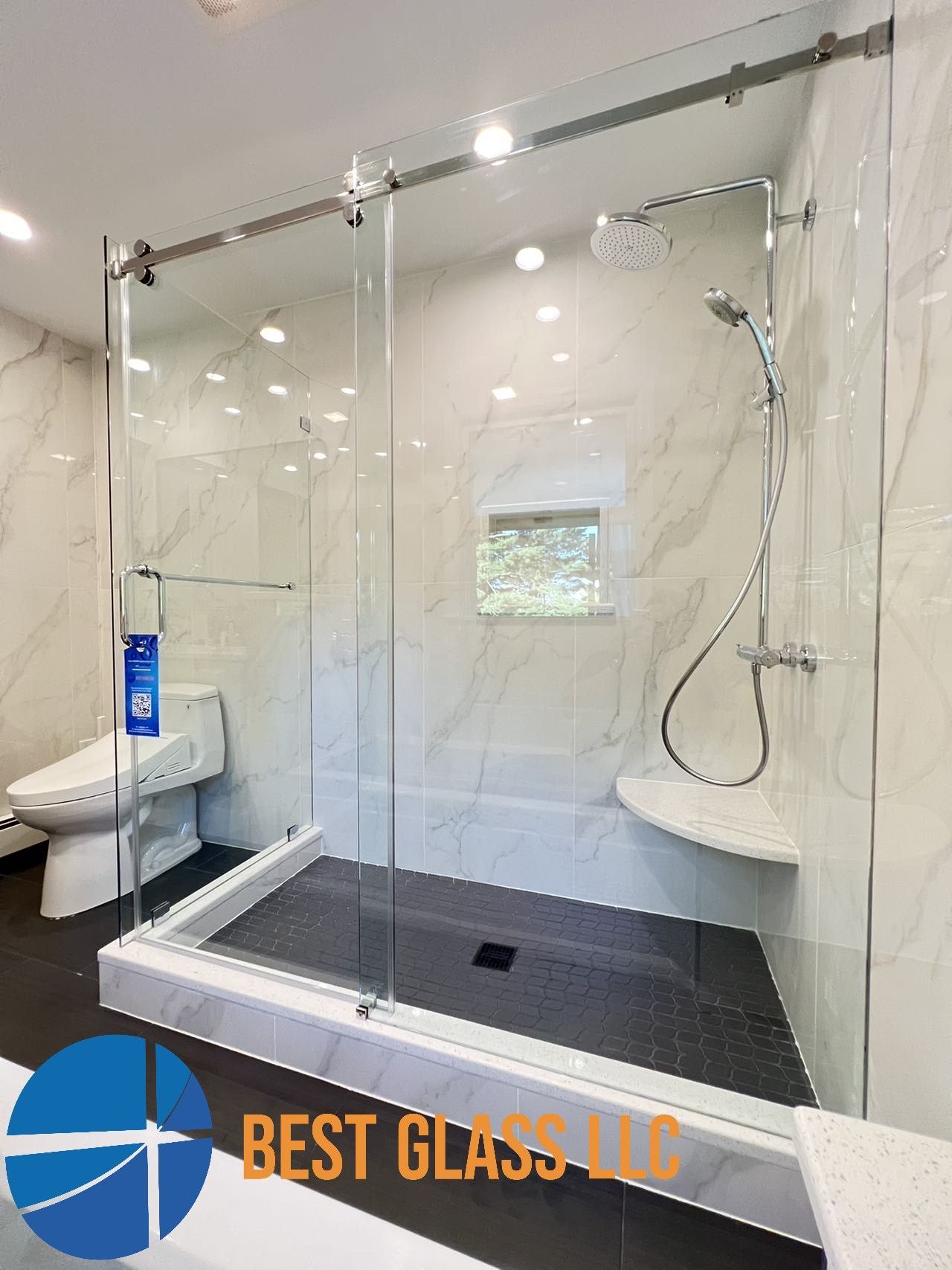 A bathroom with a walk in shower and a toilet.