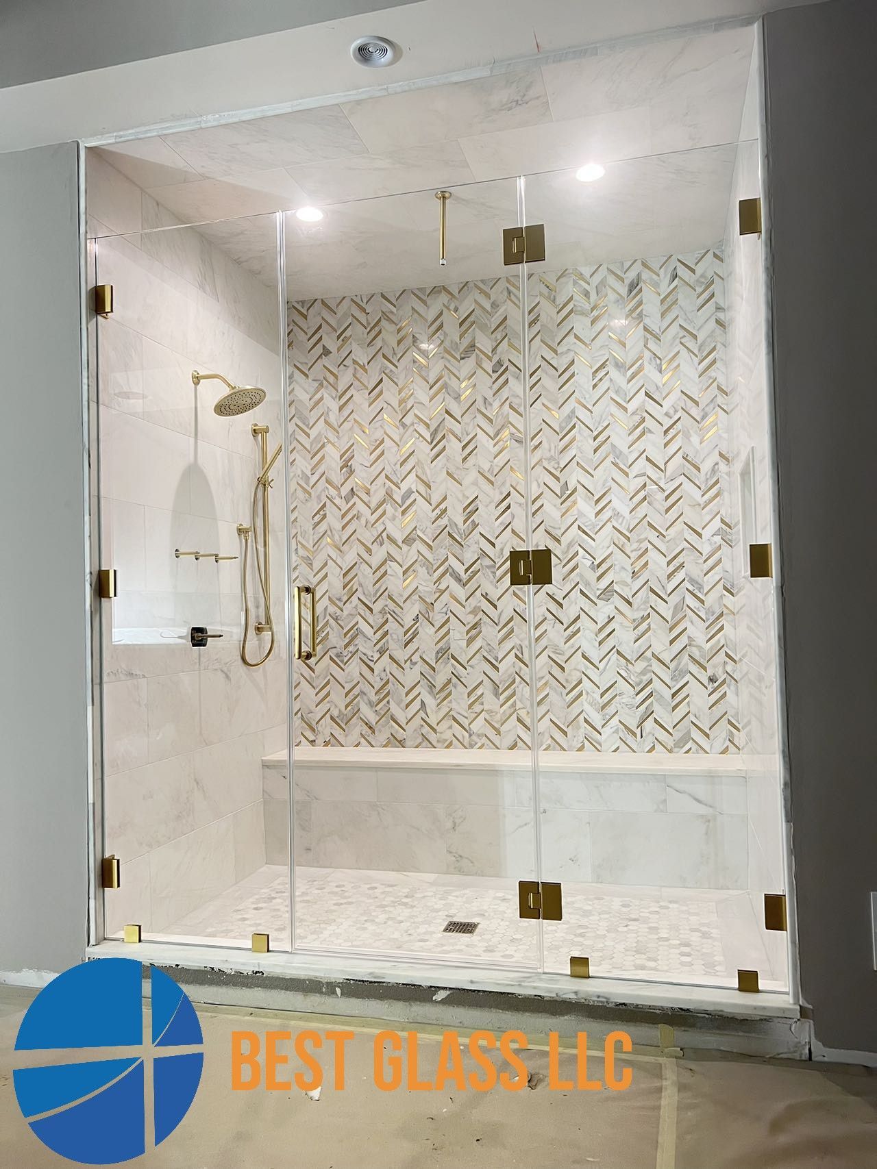 A bathroom with a shower and a sign that says best glass llc
