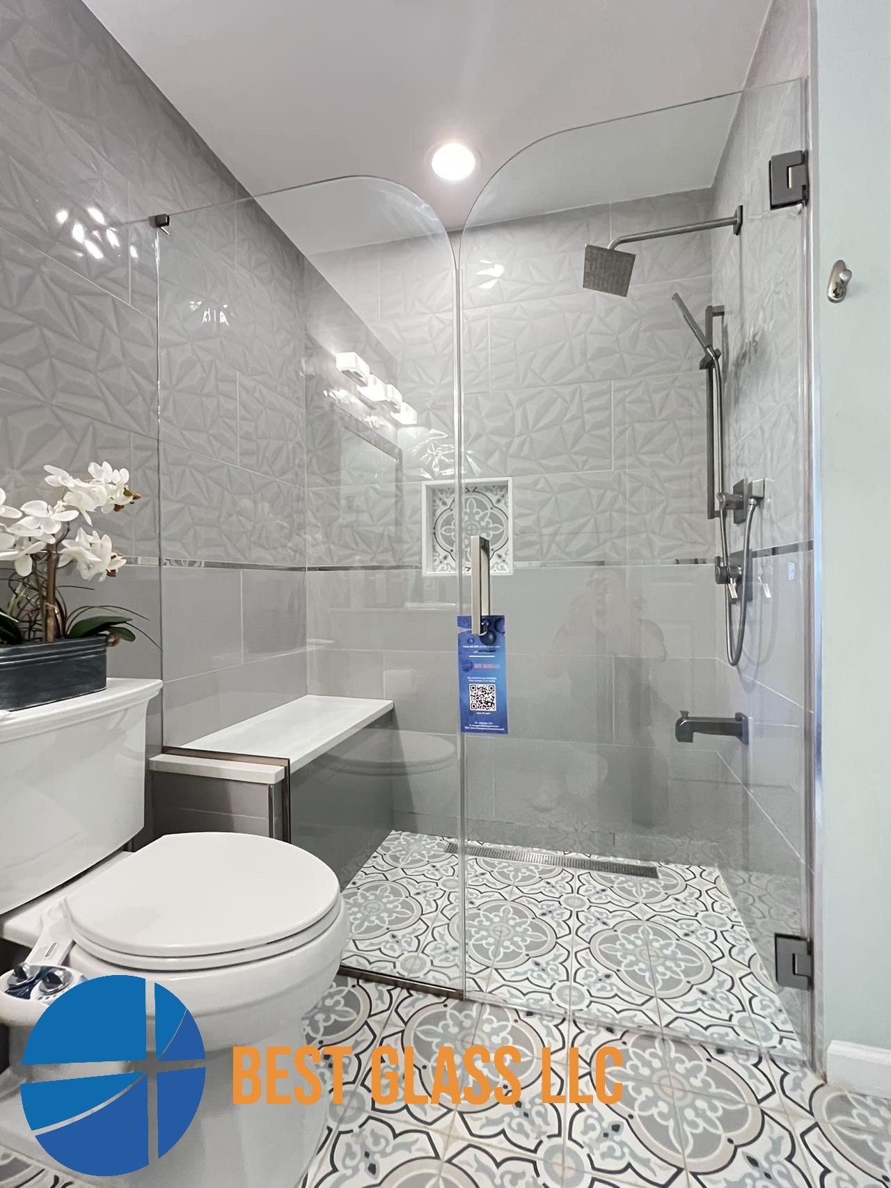 A bathroom with a toilet and a walk in shower.