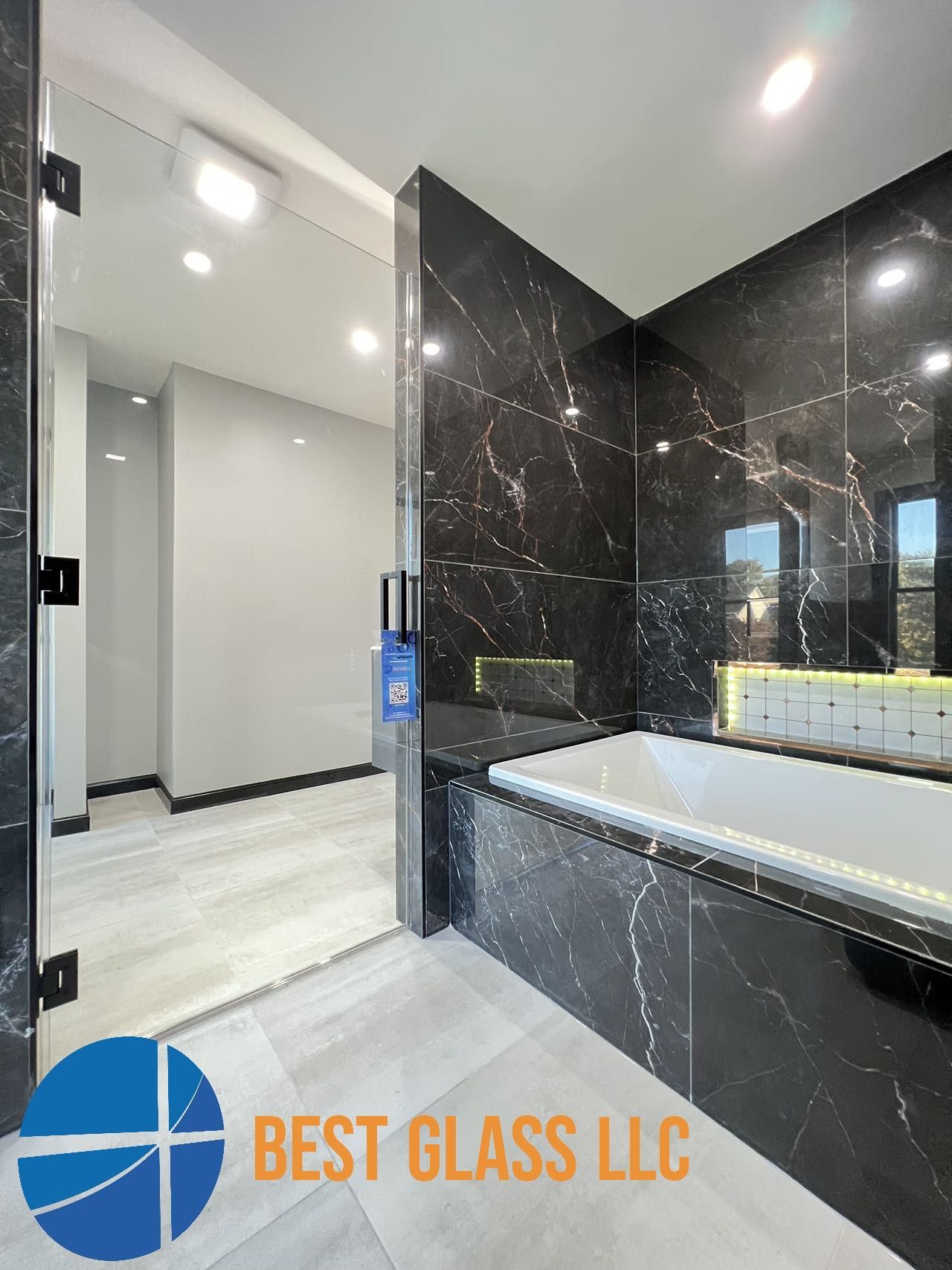 A bathroom with a bathtub and a shower door.