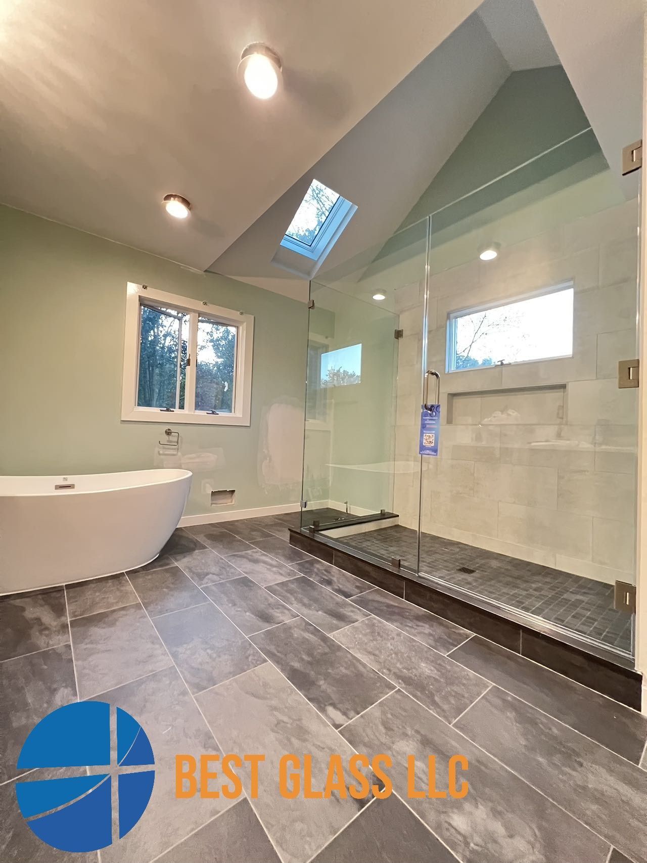 A bathroom with a walk in shower and a bathtub.