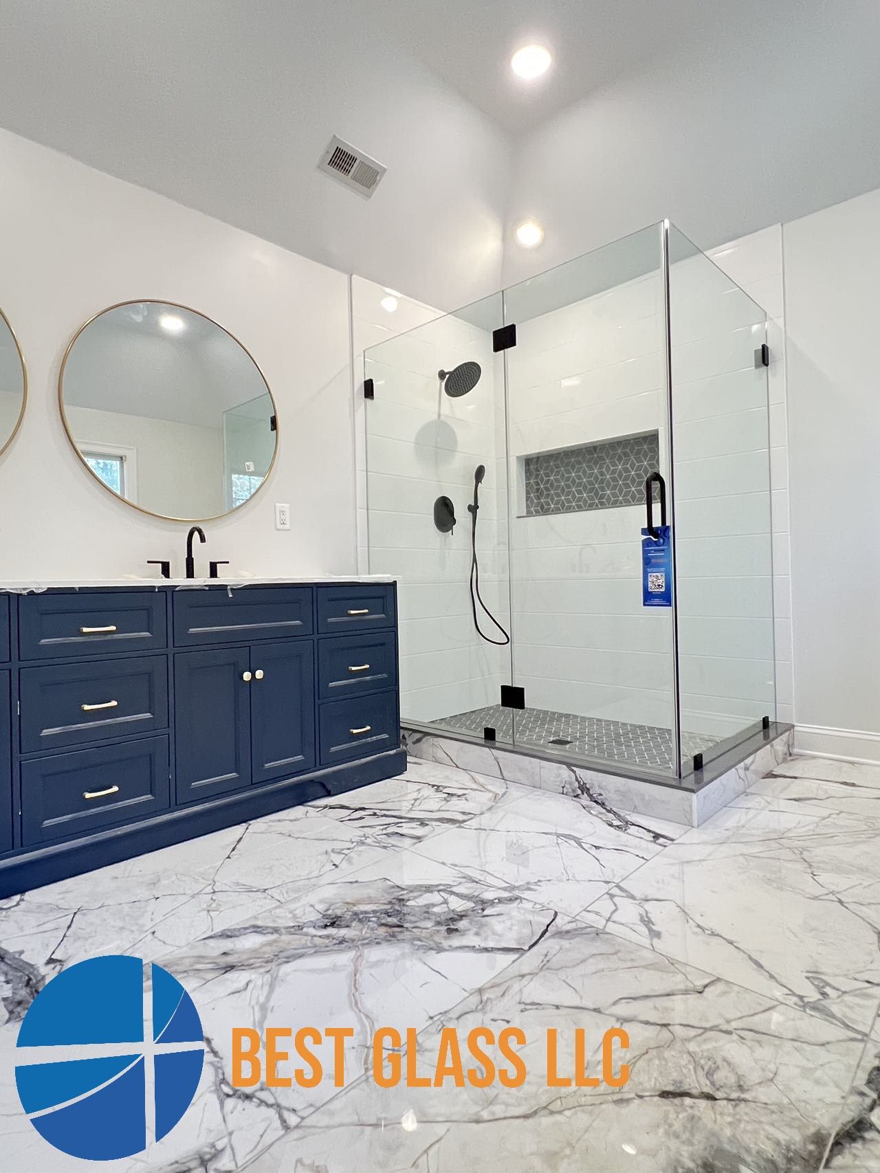 A bathroom with a walk in shower and two sinks.