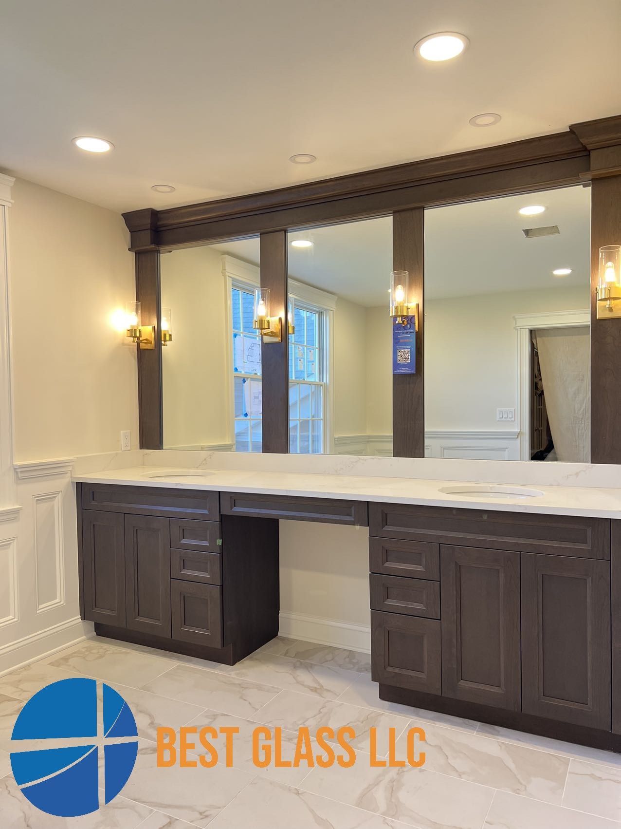 A bathroom with two sinks and a large mirror.