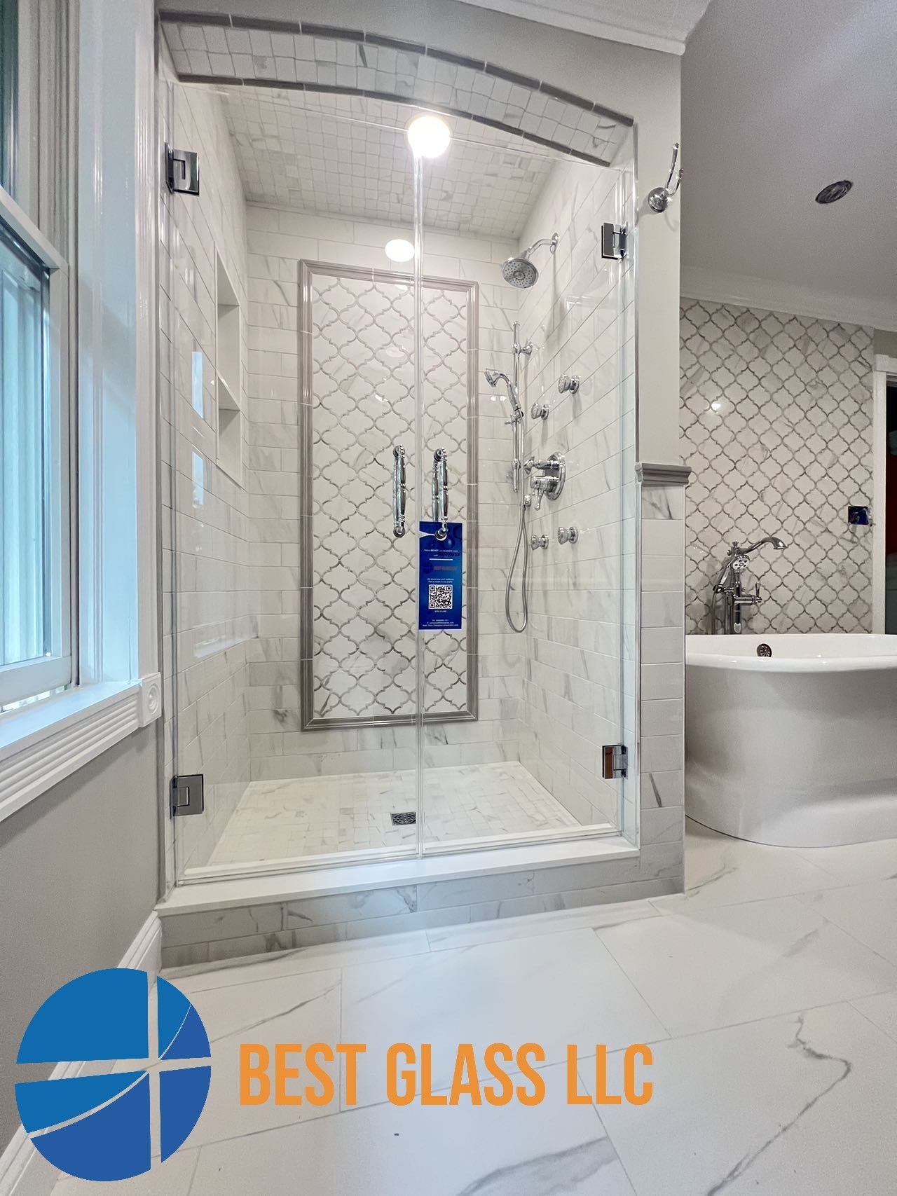 A bathroom with a walk in shower and a bathtub.