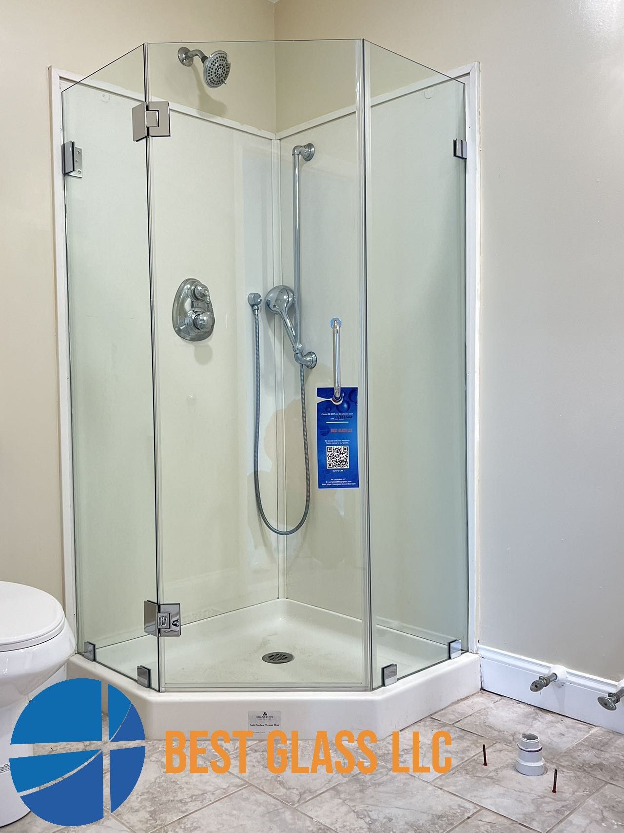 A bathroom with a shower stall and a toilet.