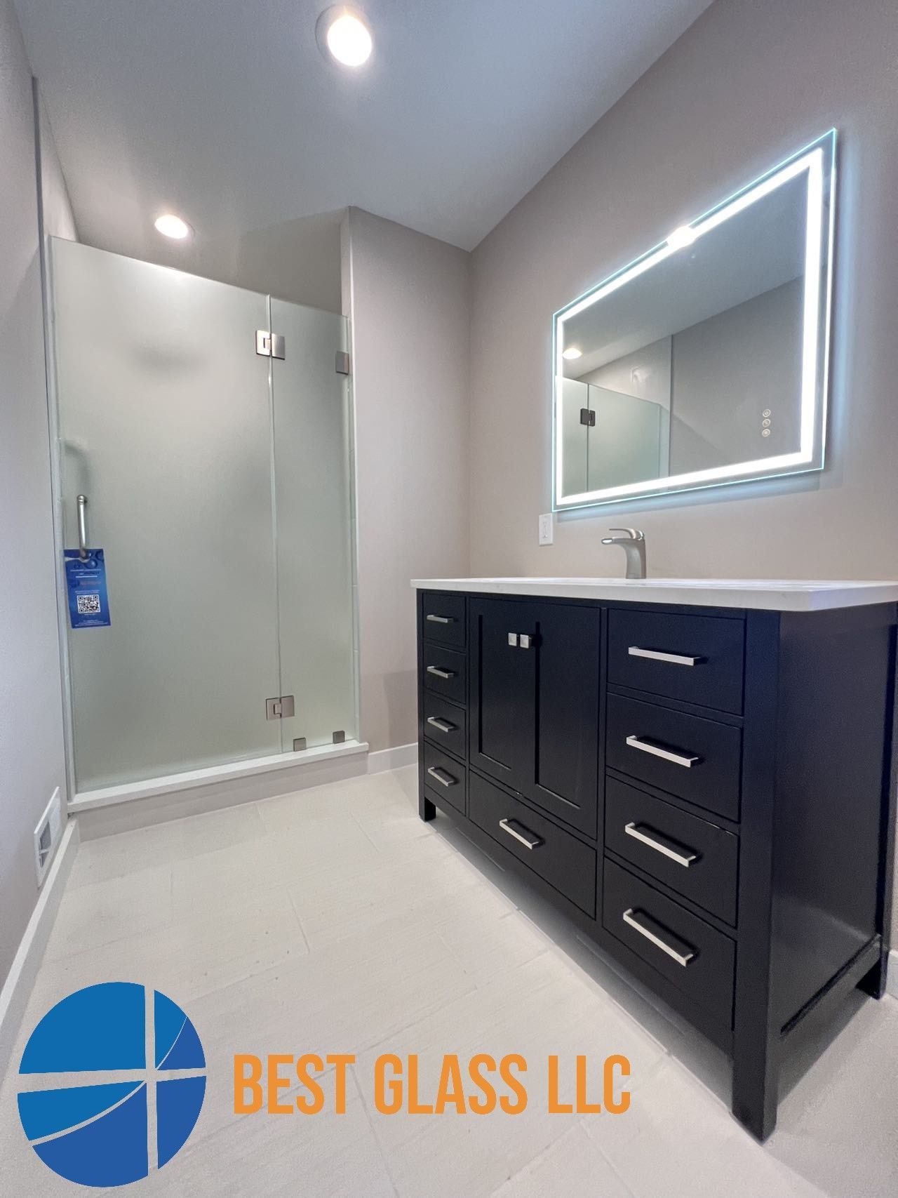 A bathroom with a sink , mirror and shower.