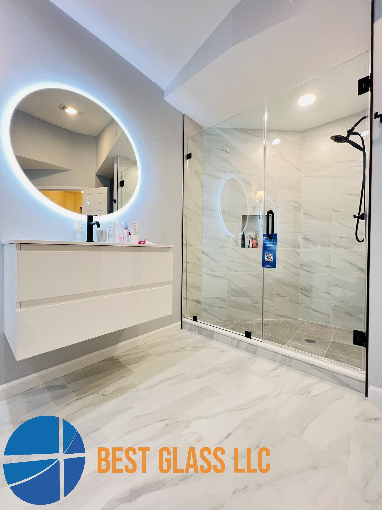 A bathroom with a walk in shower , sink and mirror.