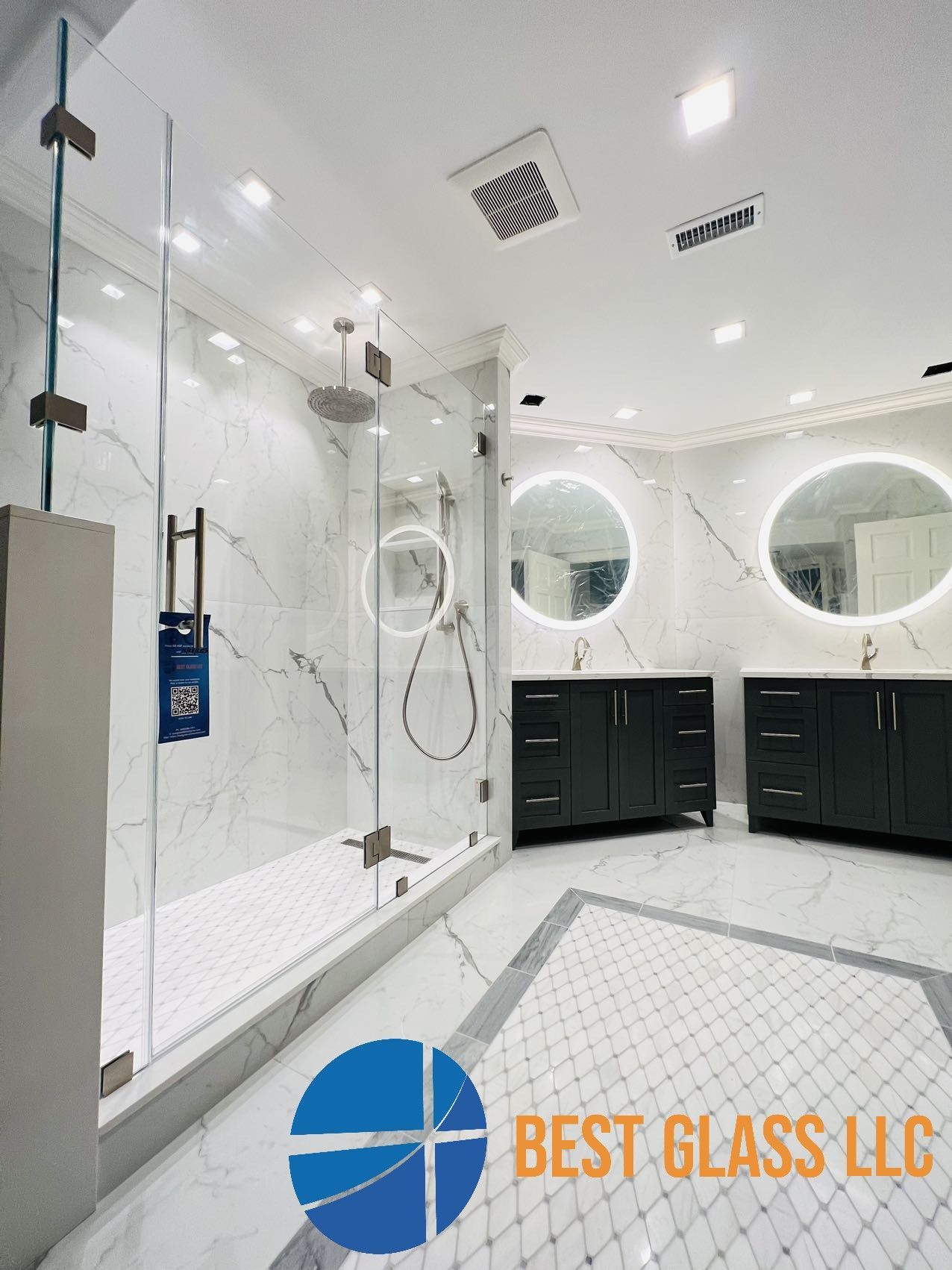 A bathroom with a walk in shower and two sinks.