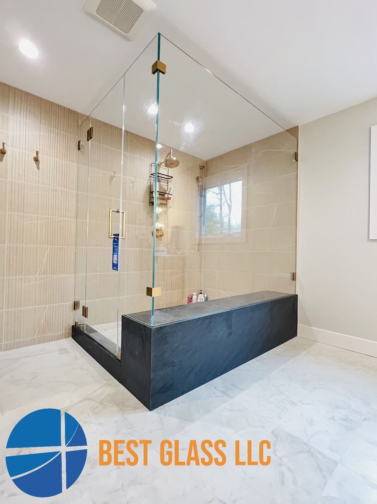 A bathroom with a walk in shower and a bench.