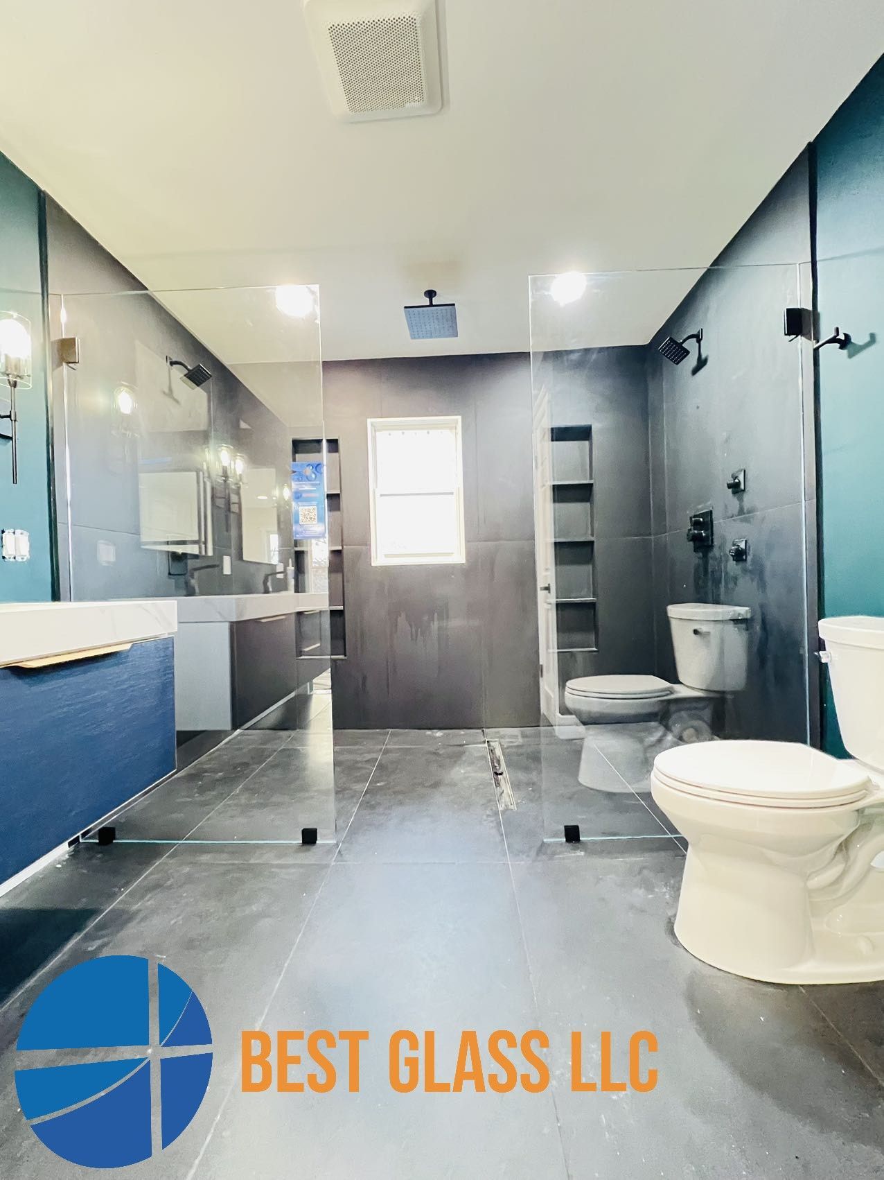 A bathroom with a toilet , sink , and shower stall.