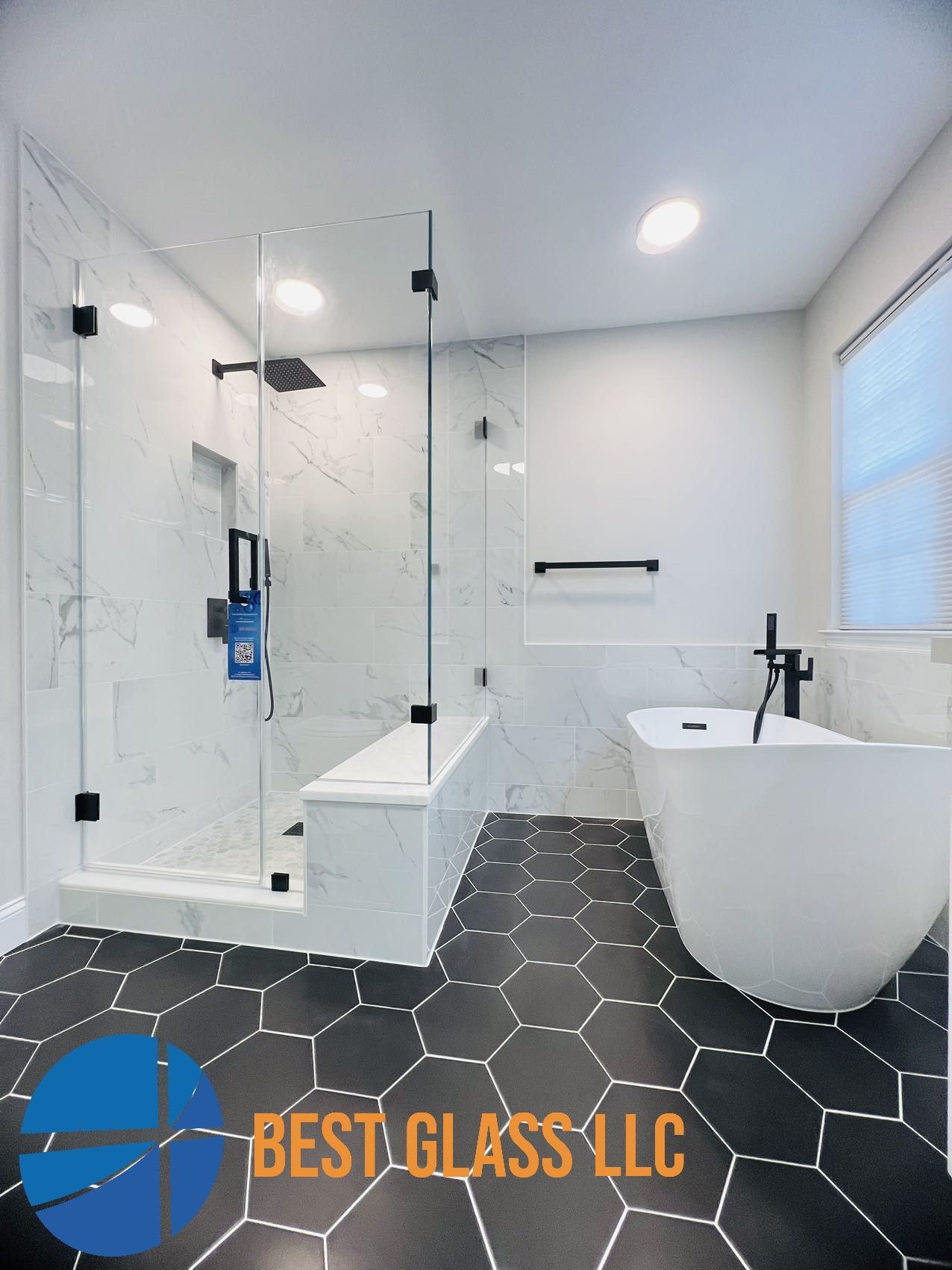 A bathroom with a bathtub , shower , and hexagonal tile floor.