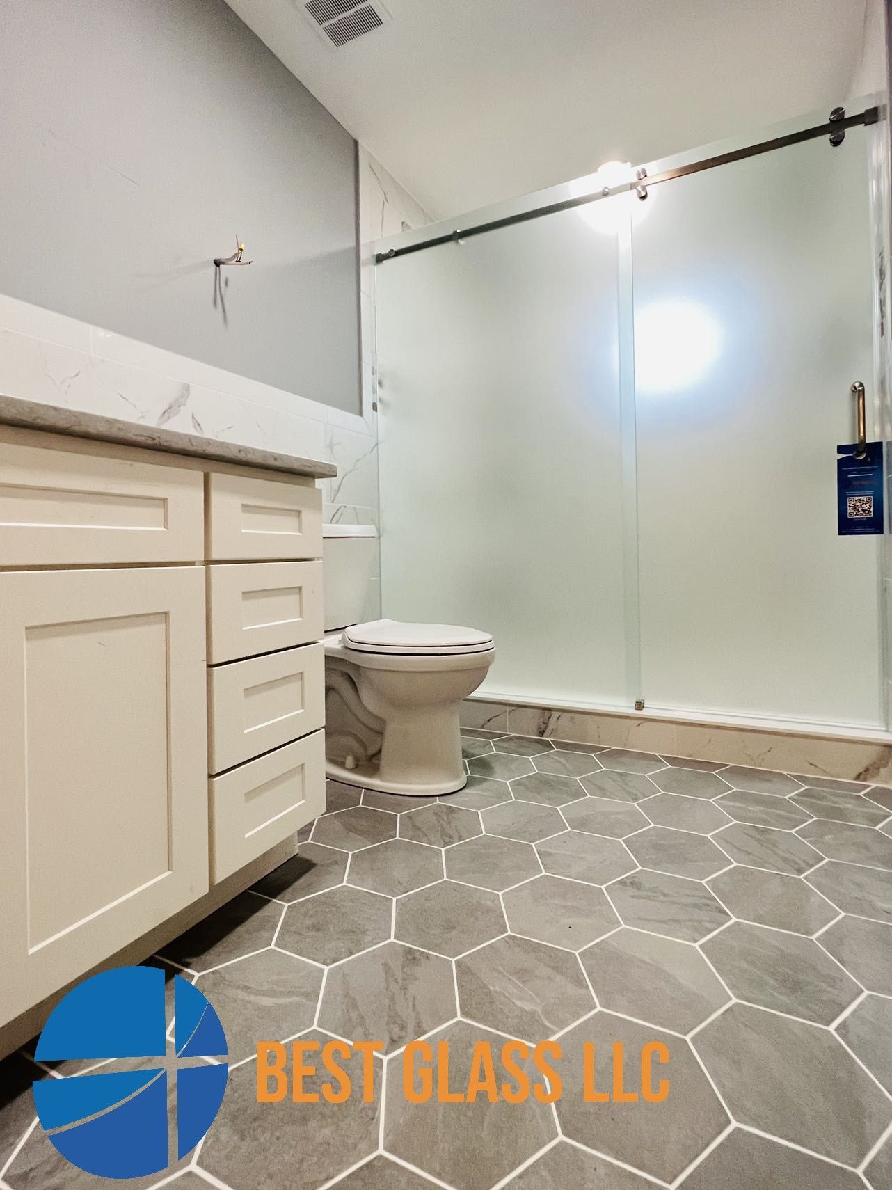 A bathroom with a toilet , sink , and shower.