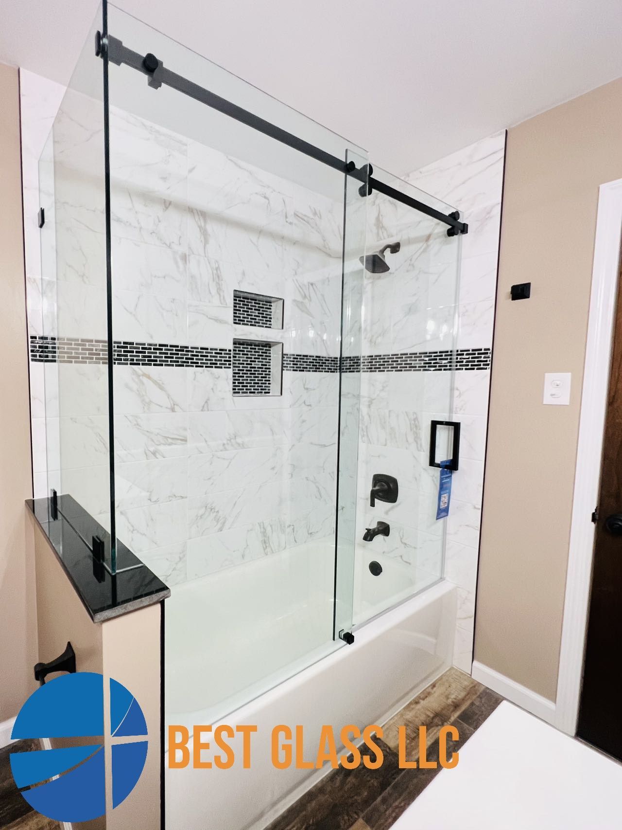 A bathroom with a sliding glass shower door