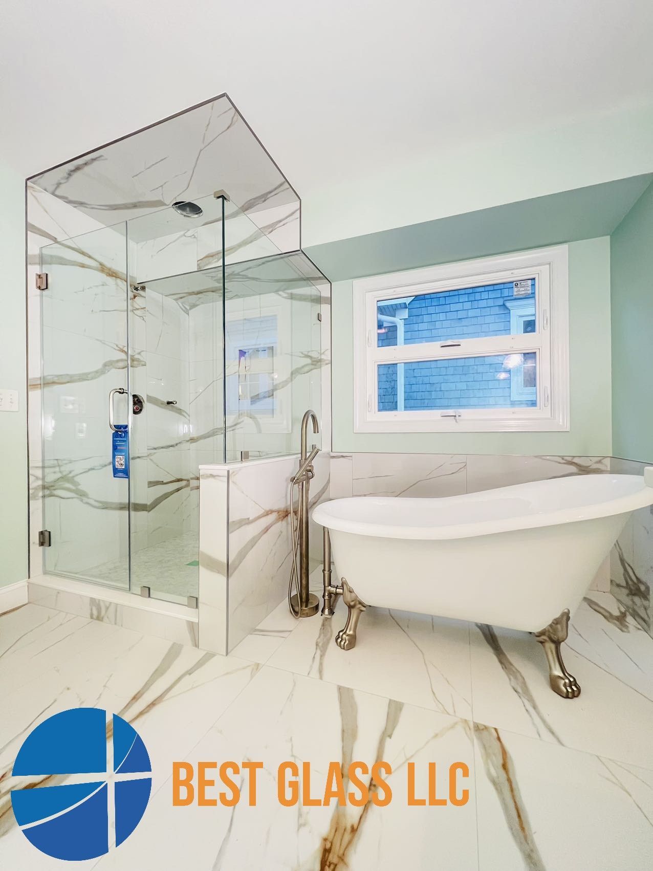 A bathroom with a claw foot tub and a walk in shower.