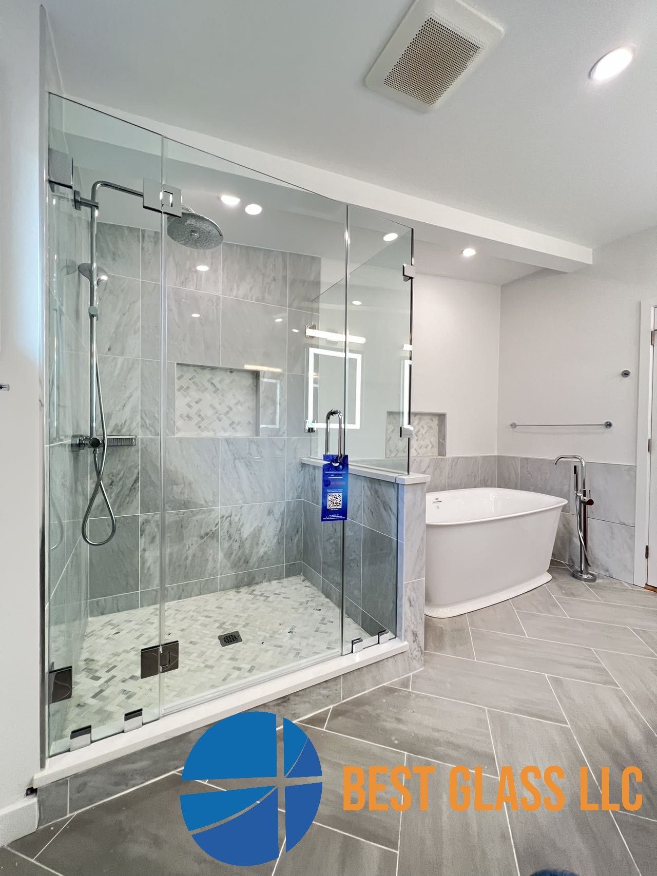 A bathroom with a walk in shower and a bathtub.