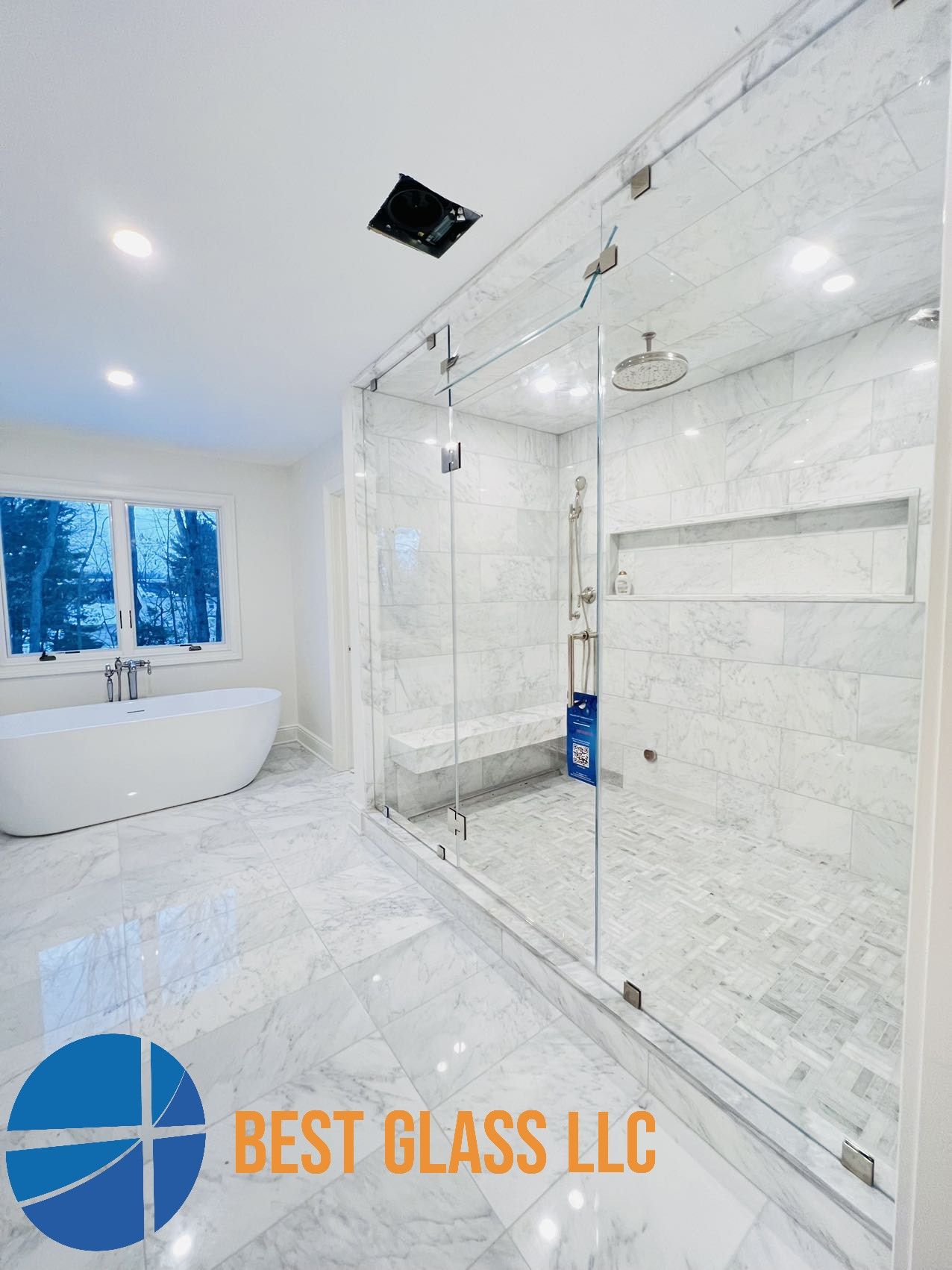 A bathroom with a walk in shower and a bathtub.