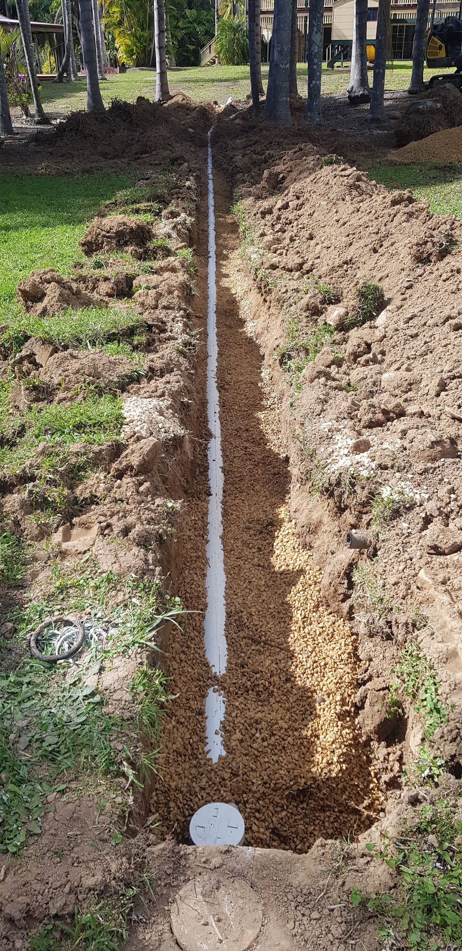 A Red And White Tractor With Tb015 On The Side — Northern Rivers and Cape Hawke Septics in Forster, NSW