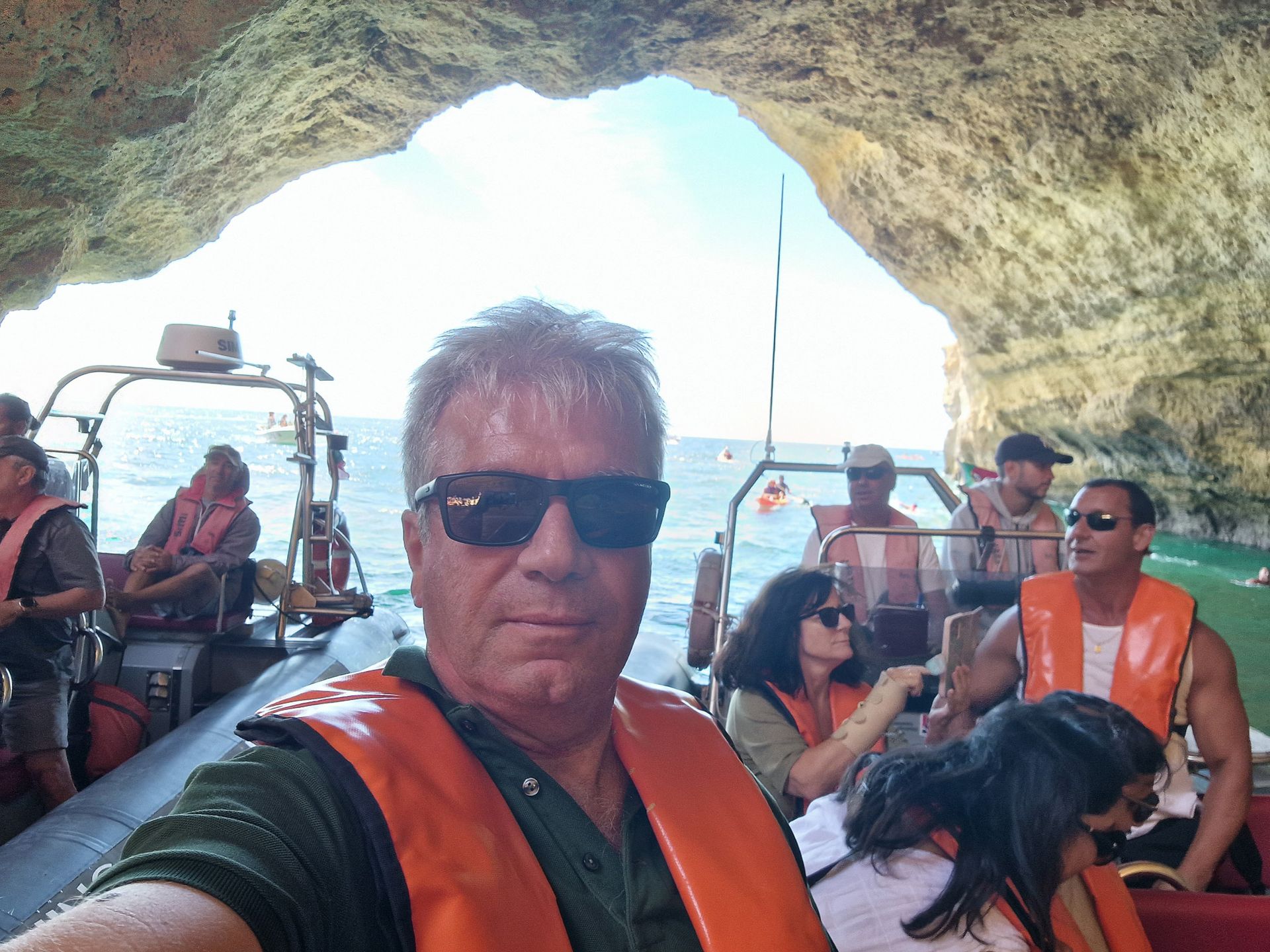 Rui from Duca leading a group in a small boat inside one oceanic cave in Algarve