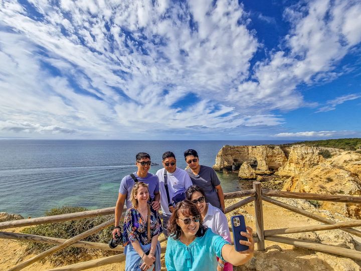 Family taking a selfie at Praia da Marinha during a transfer from Lisbon to Seville