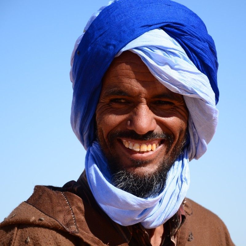 The smiling face of a desert man, the famous Touareg tribe.
Discover the quiet beauty of Mauritania with Africa DMC´s. This evocative image of a lone palm tree rising from golden sand dunes captures the peaceful solitude of the Sahara. Détours Mauritanie invites you to explore Mauritania’s highlights, from the ancient trading city of Chinguetti and the vast dunes of the Adrar region to the dramatic landscapes of the Banc d’Arguin National Park. Experience nomadic culture, desert trekking, and timeless silence under star-filled skies. With expert guidance from our local DMC, uncover the raw and authentic spirit of Mauritania, where desert and tradition shape every journey. Travel with Détours Mauritanie or Detours Mauritania Tour Operator and expert in designing Tailor Made bespoke Travel Experiences
