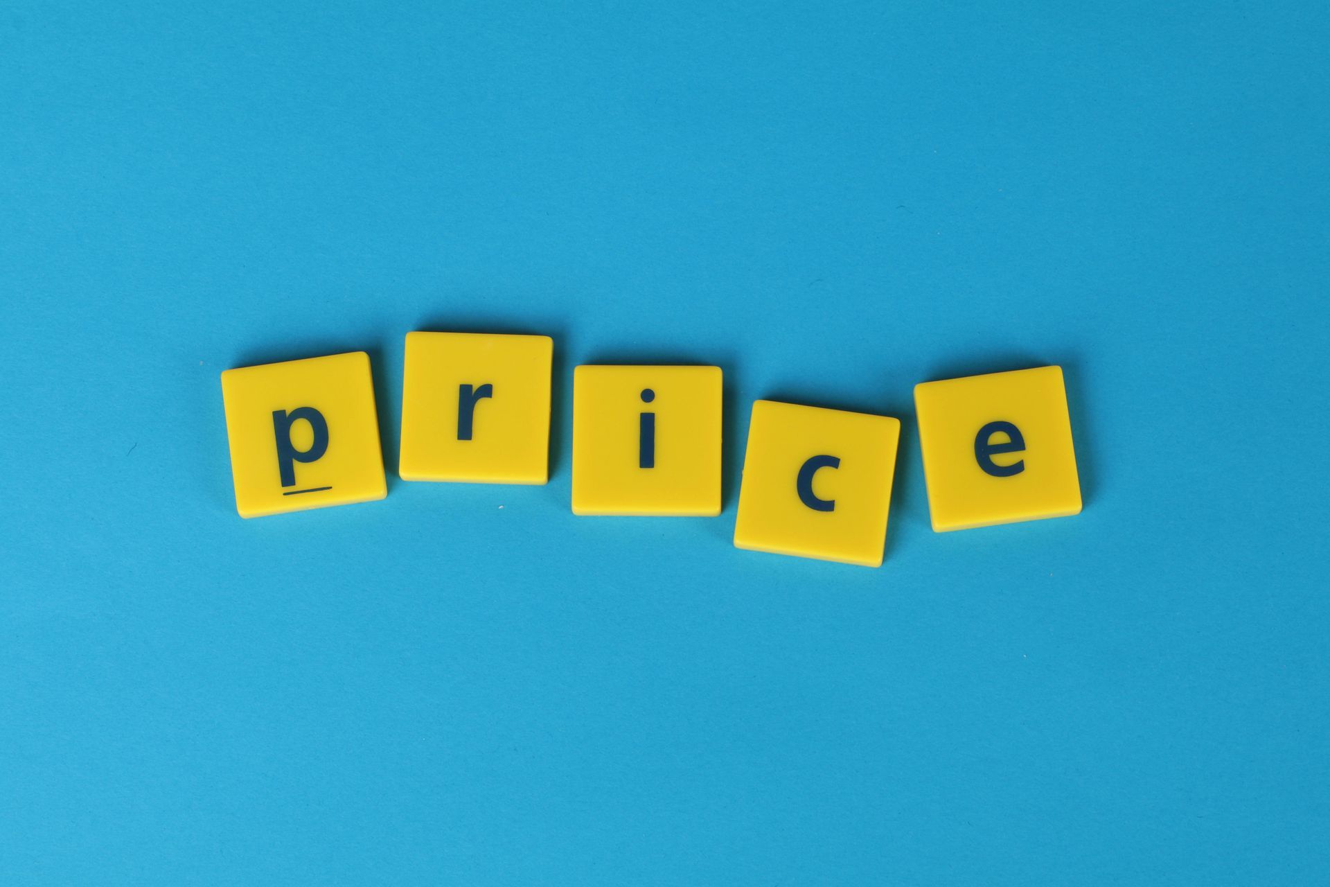 The word price is written in yellow scrabble tiles on a blue background.