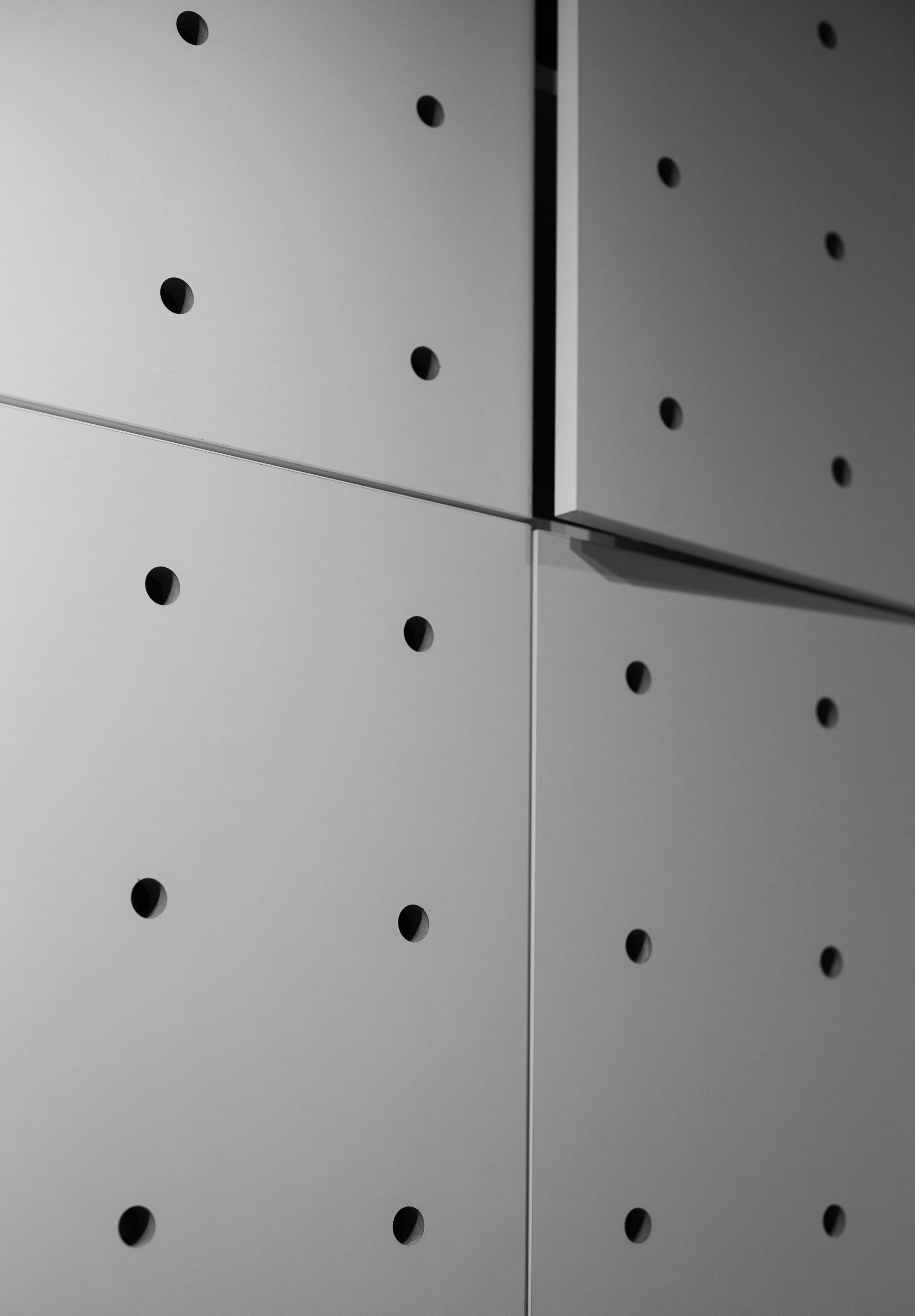 A close up of a wall with holes in it