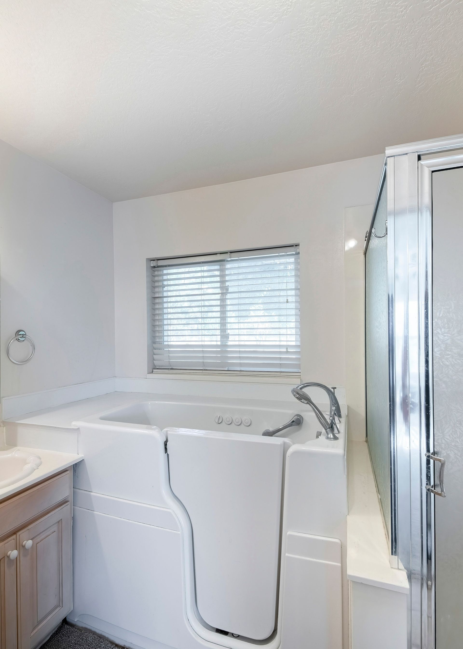 A bathroom with a walk in tub and a shower.