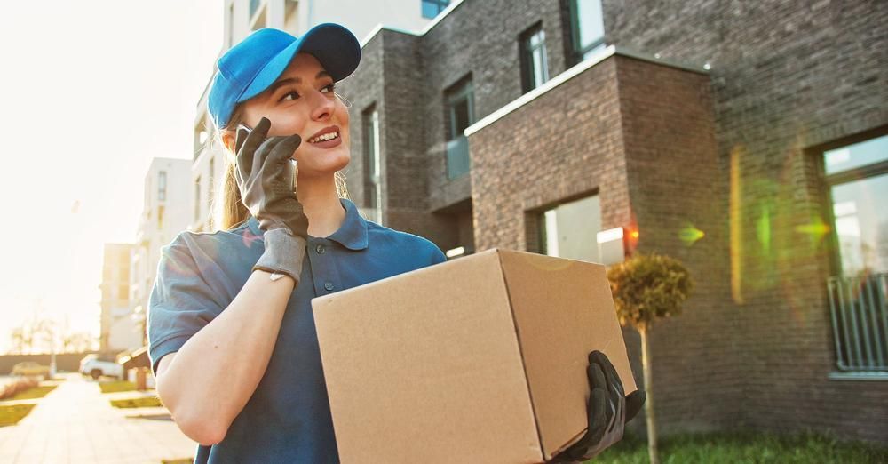 A courier driver delivering a box on a daily route.