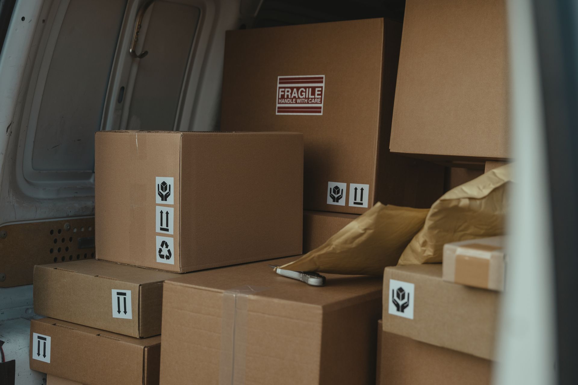 courier van filled with packages and boxes out for delivery