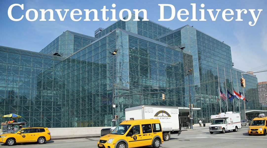 The Jacob Javitz Convention Center with box trucks and cabs passing by