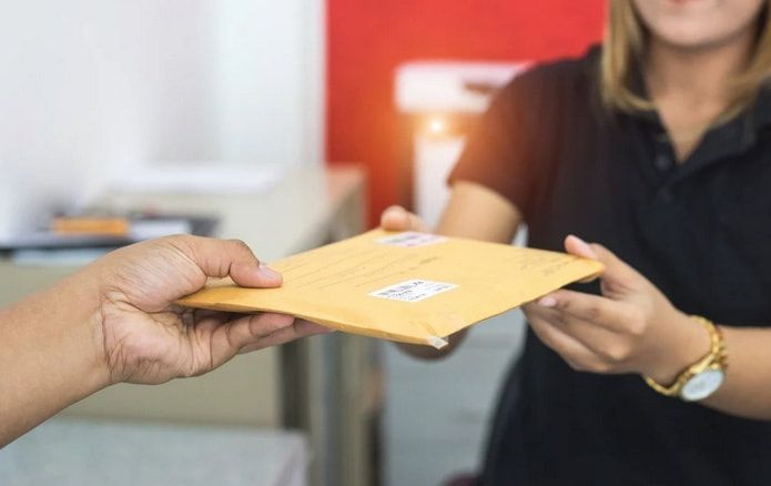 a NJ courier delivering printed documents in an envelope
