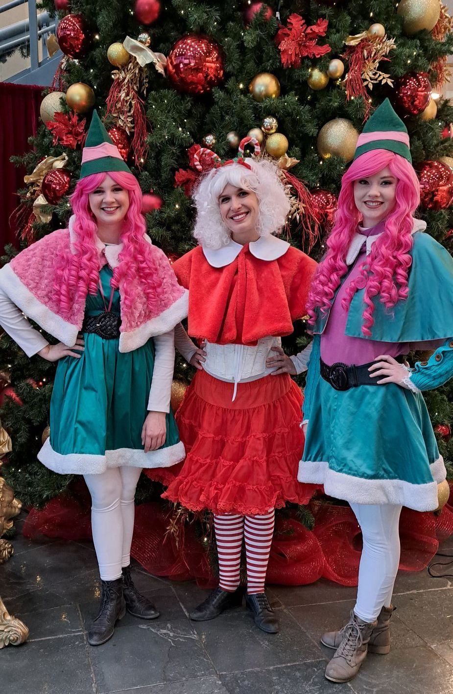 Elves and Mrs Claus pose for picture in front of Christmas Tree at Calgary corporate event