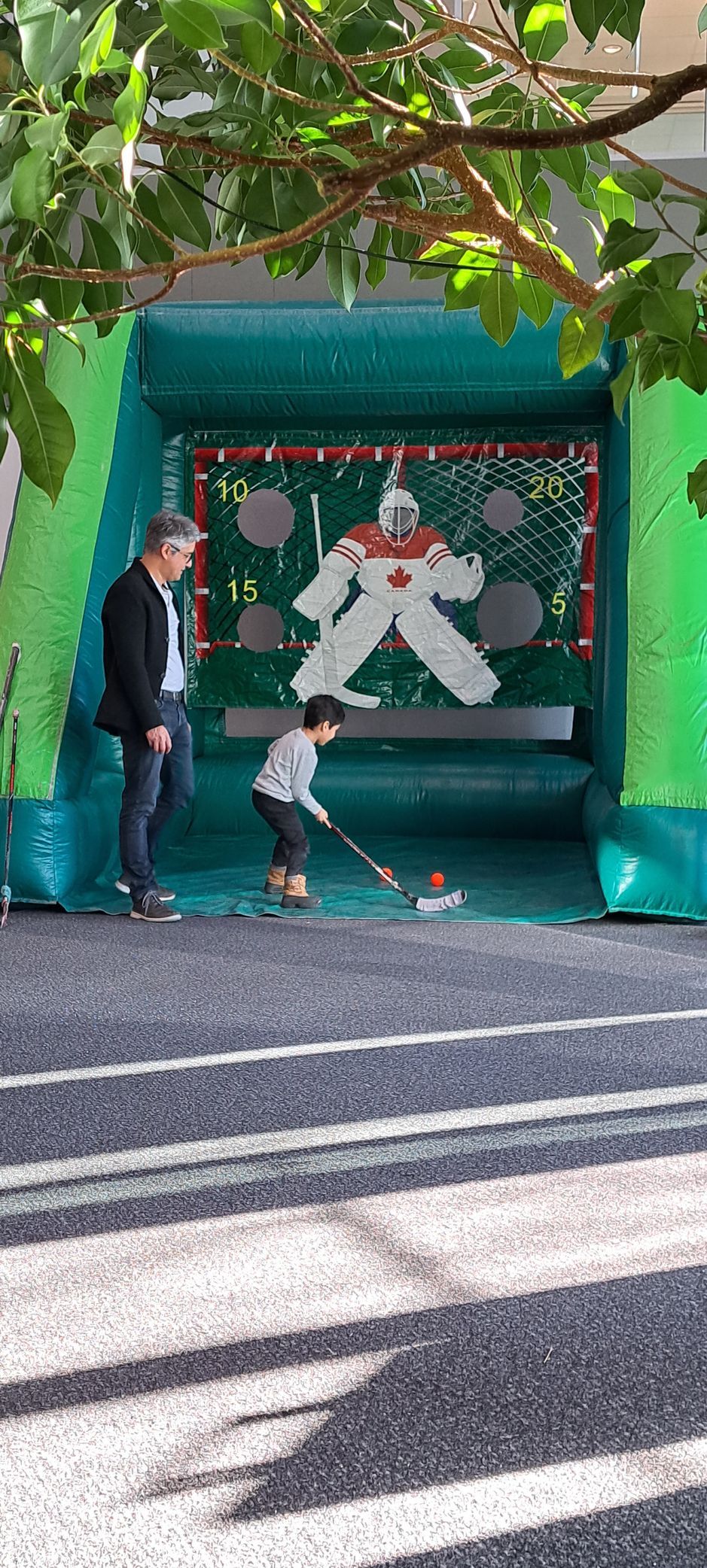 child and father playing inflatable game at outdoor event in Calgary, Alberta