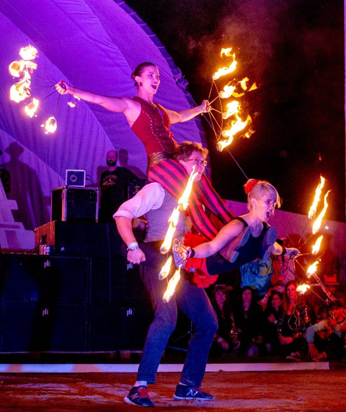 three fire artists perform live act at outdoor event in Calgary, Alberta