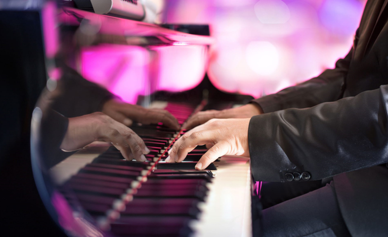 close up of pianist playing the keys at a live event