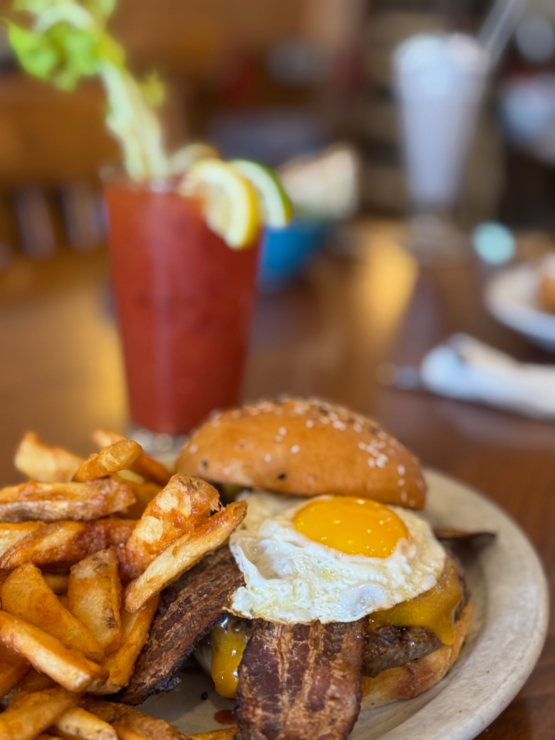 A blue bowl filled with chicken , lettuce , avocado , and a dipping sauce.