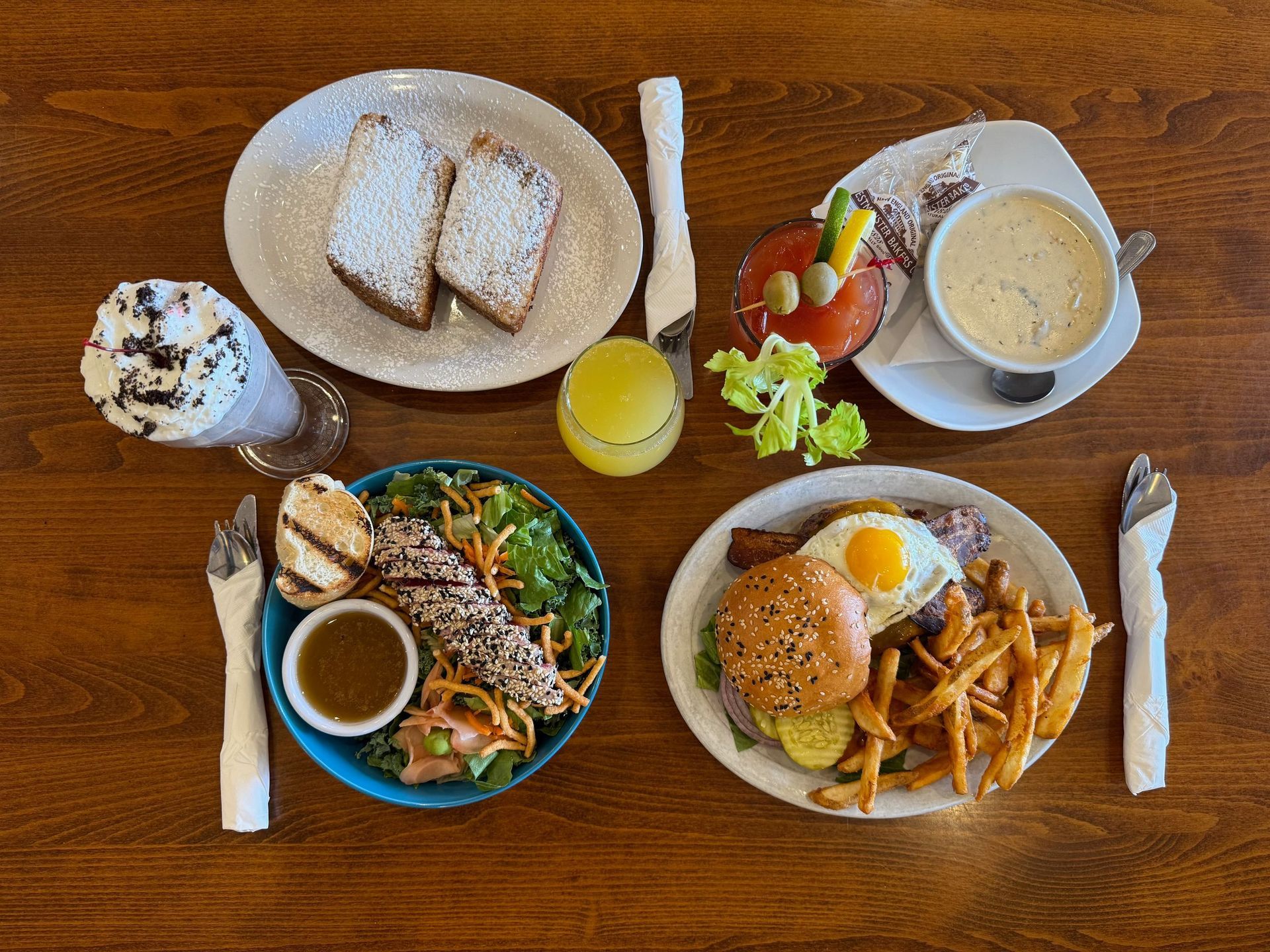 A table topped with plates of food and drinks.